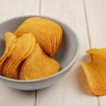 top-view-crispy-potato-chips-bowl-beige-wooden-table-360x240